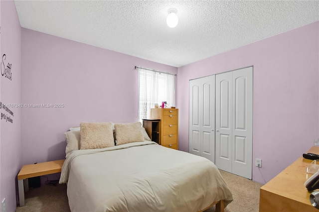carpeted bedroom with a closet and a textured ceiling