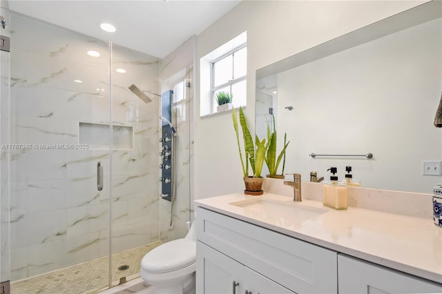 full bathroom featuring recessed lighting, a marble finish shower, vanity, and toilet