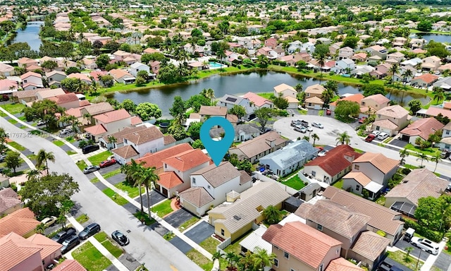 birds eye view of property with a residential view and a water view