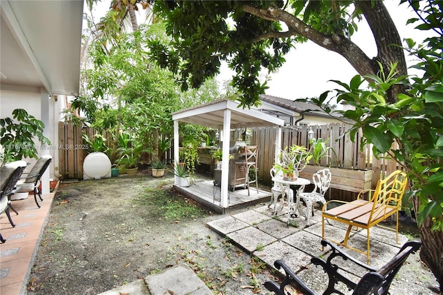 view of patio / terrace featuring fence and a wooden deck