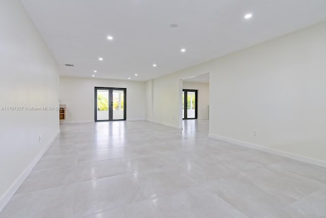 spare room with light tile patterned floors, visible vents, baseboards, recessed lighting, and french doors
