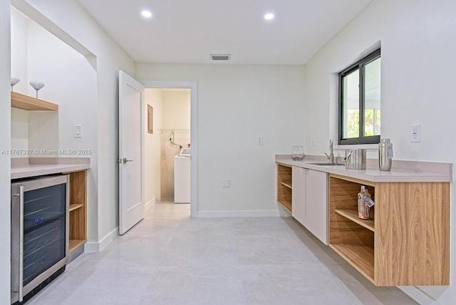 full bathroom with visible vents, beverage cooler, washer / clothes dryer, recessed lighting, and vanity