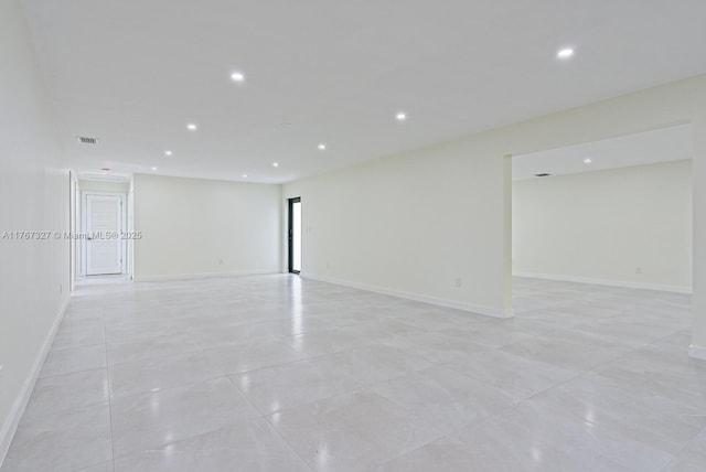 empty room featuring light tile patterned floors, visible vents, recessed lighting, and baseboards