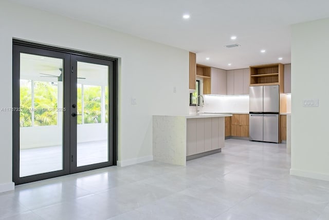 kitchen with light countertops, french doors, freestanding refrigerator, modern cabinets, and open shelves