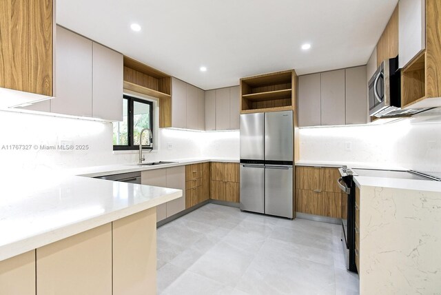 kitchen featuring a sink, appliances with stainless steel finishes, modern cabinets, and open shelves