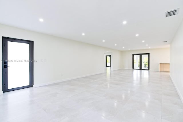 spare room featuring visible vents, recessed lighting, french doors, and baseboards