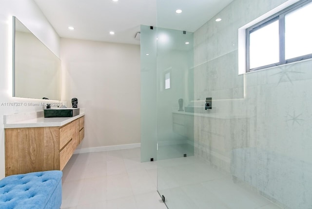 bathroom featuring a walk in shower, recessed lighting, tile patterned flooring, baseboards, and vanity