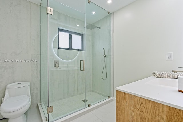 bathroom with toilet, a stall shower, recessed lighting, tile patterned flooring, and vanity
