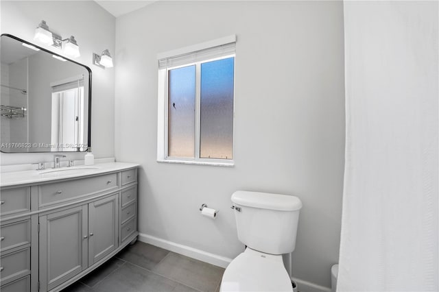 bathroom with toilet, a shower with shower curtain, tile patterned flooring, baseboards, and vanity
