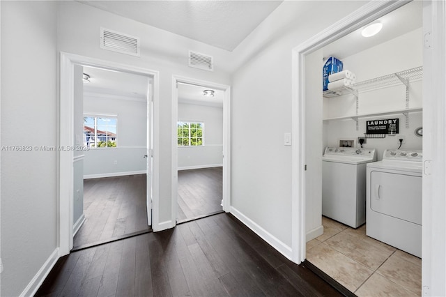 washroom featuring washer and dryer, baseboards, visible vents, and hardwood / wood-style floors