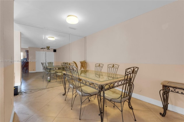 dining area featuring light tile patterned floors and baseboards
