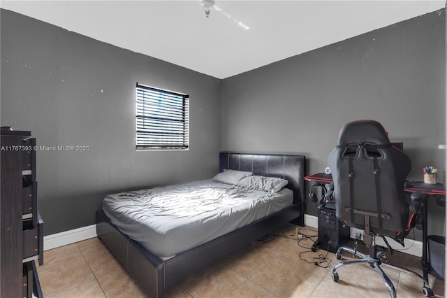 bedroom with tile patterned floors and baseboards