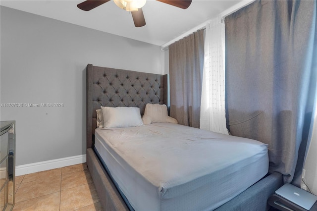 bedroom featuring light tile patterned floors, a ceiling fan, and baseboards