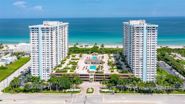 birds eye view of property with a water view and a view of city