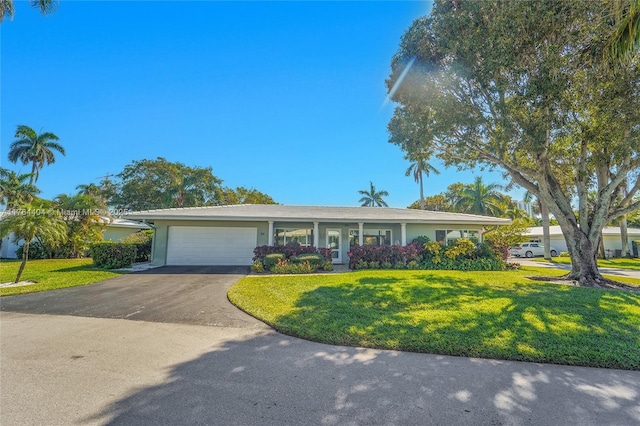 1431 S Ocean Blvd, Lauderdale By The Sea, FL 33062 - single story home featuring stucco siding, a front lawn, aphalt driveway, and a garage