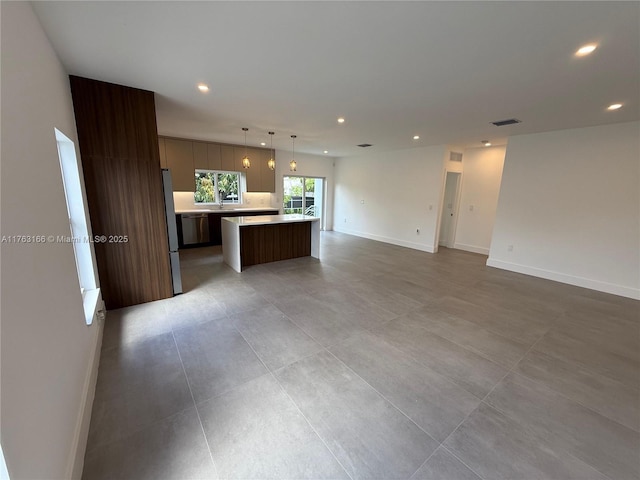 3431 NW 14th Ter, Miami, FL 33125 - kitchen with a kitchen island, open floor plan, light countertops, and recessed lighting