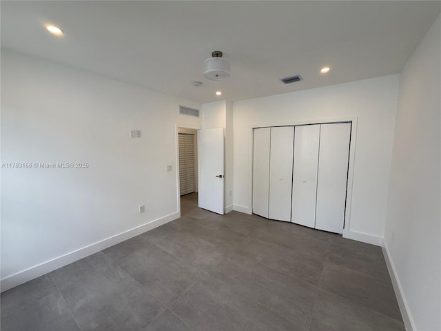 3431 NW 14th Ter, Miami, FL 33125 - unfurnished bedroom with baseboards, recessed lighting, a closet, and visible vents