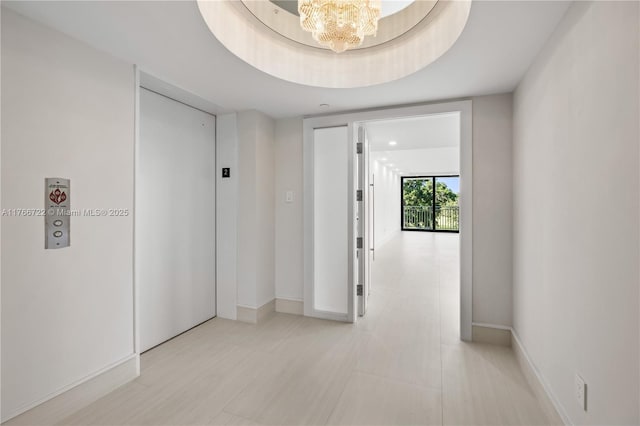 700 Coral Way Unit 2, Coral Gables, FL 33134 - corridor with elevator, a chandelier, and baseboards