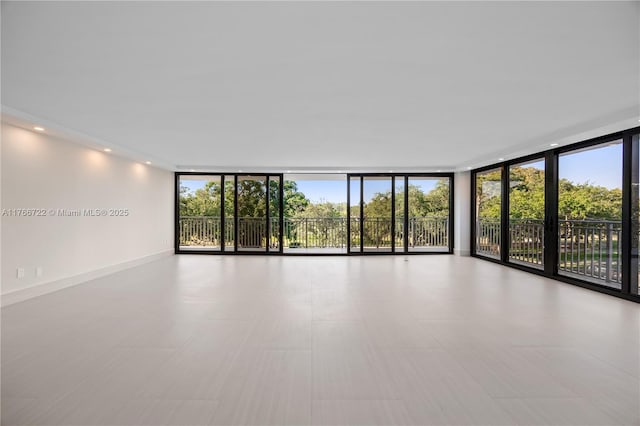 700 Coral Way Unit 2, Coral Gables, FL 33134 - unfurnished room with a wall of windows and healthy amount of natural light