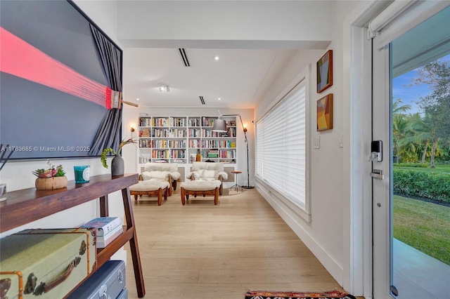 corridor with light wood-style flooring and recessed lighting