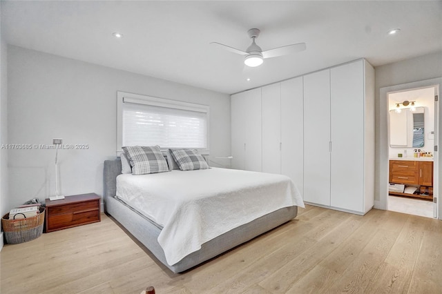 bedroom featuring recessed lighting, light wood-style flooring, ceiling fan, and ensuite bath