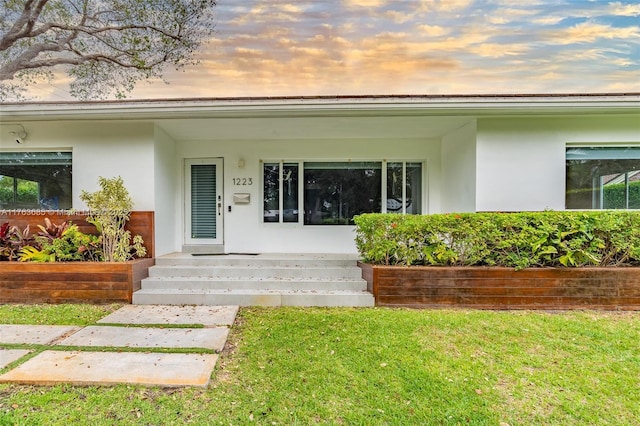 entrance to property featuring stucco siding