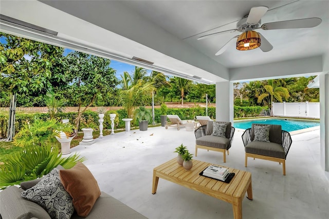 view of patio with a fenced in pool, a ceiling fan, and fence