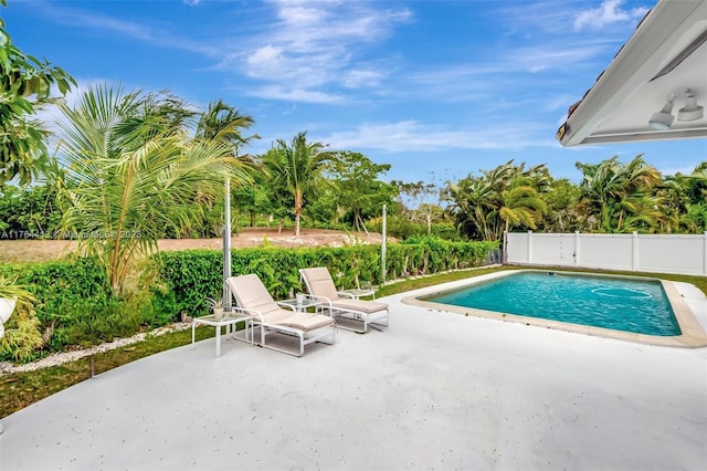 view of swimming pool featuring fence, a fenced in pool, and a patio area