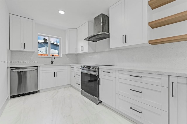 kitchen featuring open shelves, appliances with stainless steel finishes, white cabinets, wall chimney exhaust hood, and a sink