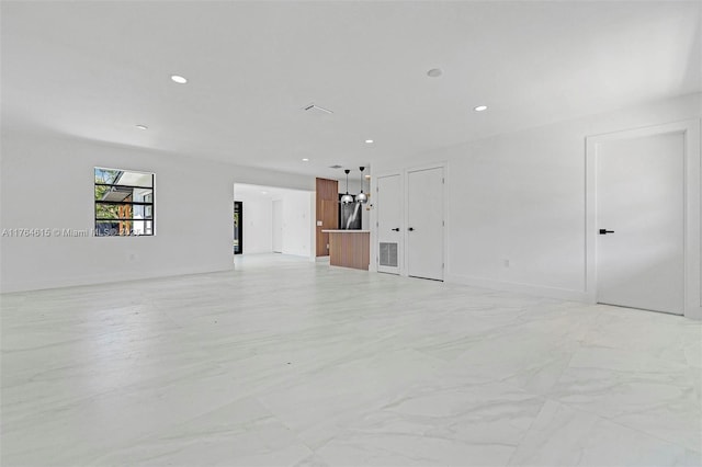 empty room featuring recessed lighting, visible vents, marble finish floor, and an inviting chandelier