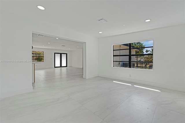 unfurnished room featuring visible vents, recessed lighting, and plenty of natural light