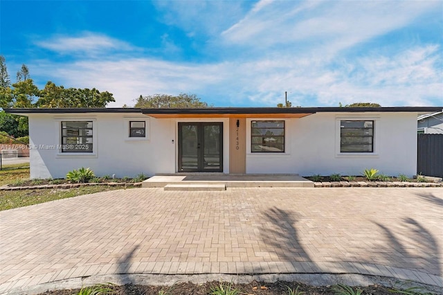 view of front of home with french doors and stucco siding
