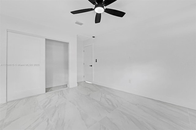 spare room with visible vents, marble finish floor, baseboards, and ceiling fan