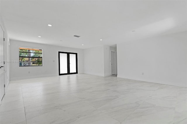 unfurnished room with visible vents, recessed lighting, french doors, and baseboards