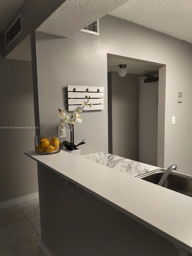 16465 NE 22nd Ave Unit 114, North Miami Beach, FL 33160 - interior space featuring light countertops, a sink, marble finish floor, baseboards, and visible vents