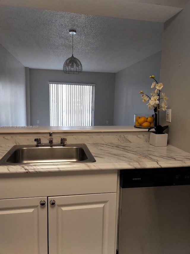 16465 NE 22nd Ave Unit 114, North Miami Beach, FL 33160 - kitchen with decorative light fixtures, a sink, dishwasher, a textured ceiling, and white cabinets