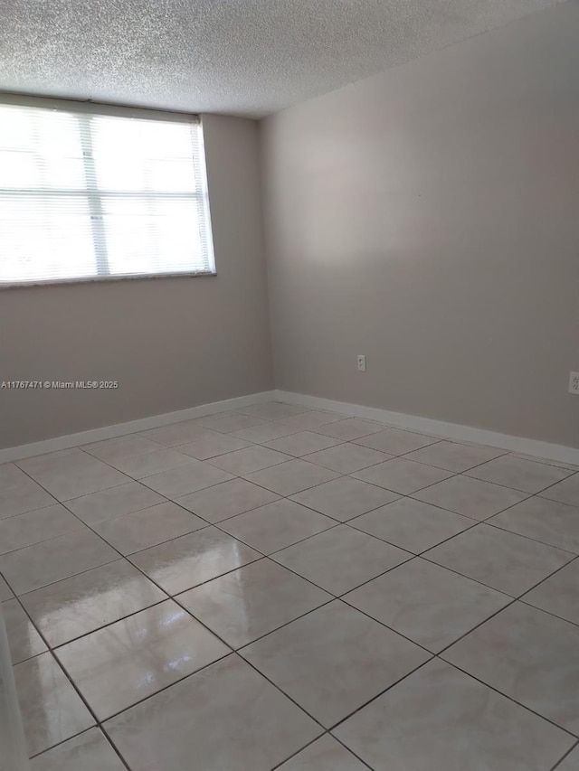 16465 NE 22nd Ave Unit 114, North Miami Beach, FL 33160 - unfurnished room with baseboards and a textured ceiling
