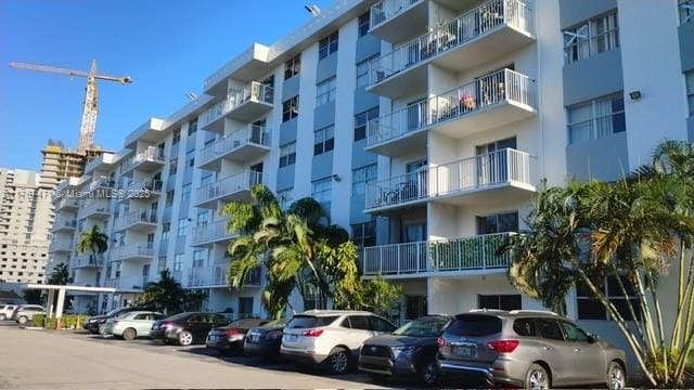16465 NE 22nd Ave Unit 114, North Miami Beach, FL 33160 - view of property featuring uncovered parking