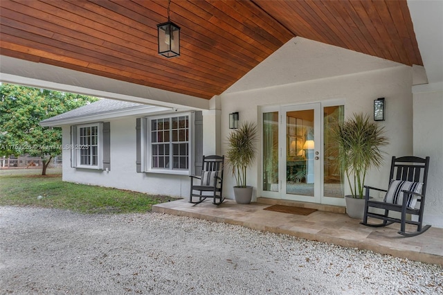 doorway to property featuring stucco siding and a patio area