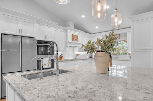 kitchen featuring white cabinets, backsplash, and stainless steel appliances