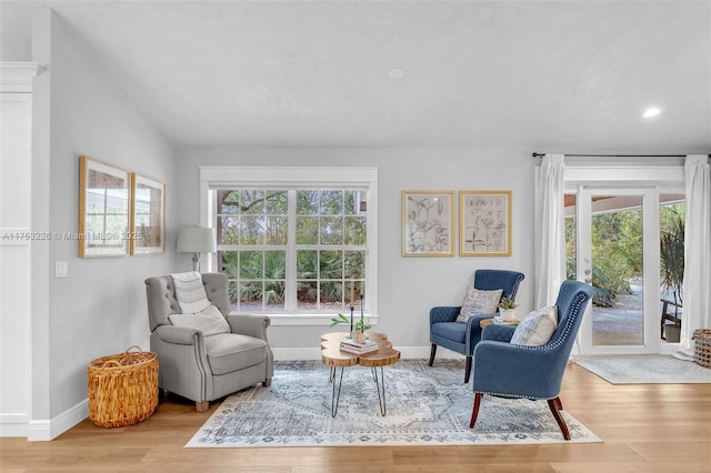 living area featuring recessed lighting, baseboards, lofted ceiling, and wood finished floors