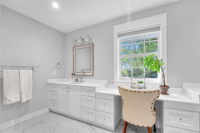 bathroom with baseboards, marble finish floor, and vanity