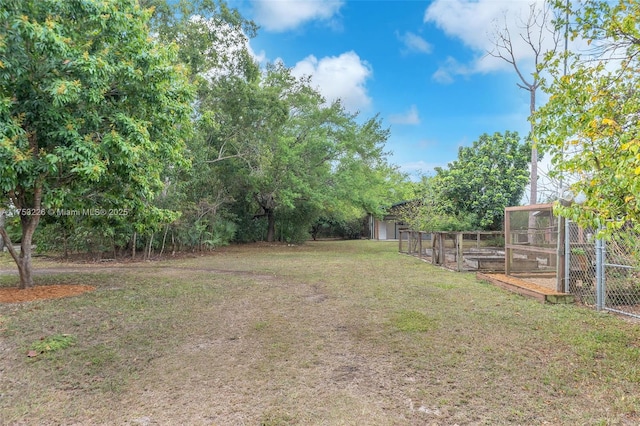 view of yard with a garden and an outdoor structure