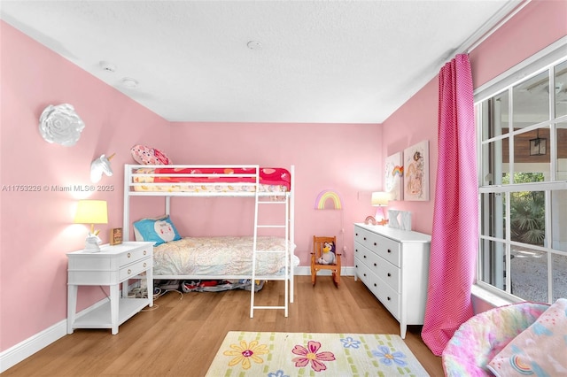bedroom featuring baseboards and wood finished floors