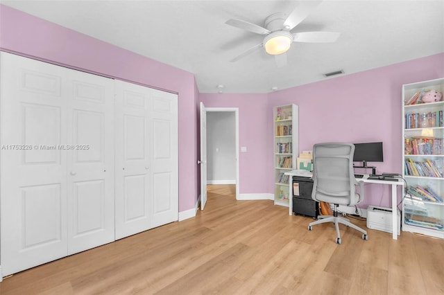 office space featuring baseboards, visible vents, a ceiling fan, and wood finished floors