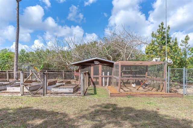 view of yard with an outdoor structure, exterior structure, and fence