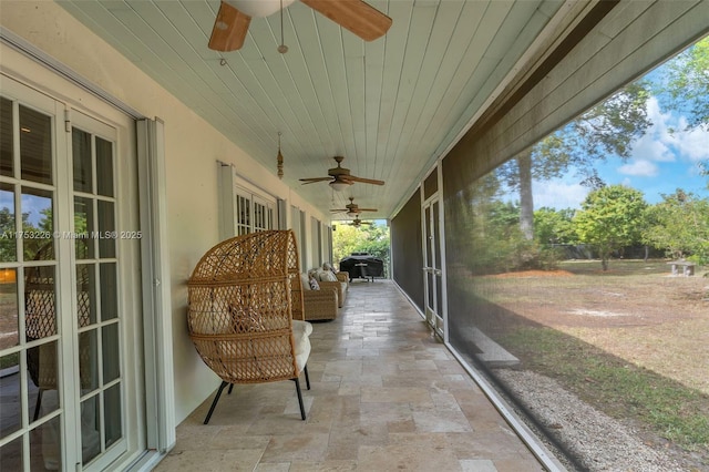 sunroom / solarium with a ceiling fan