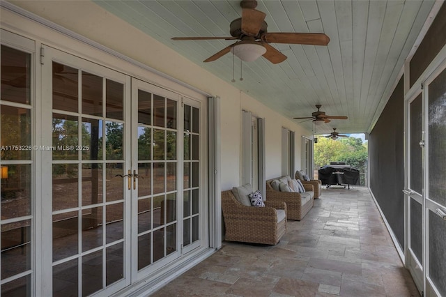 unfurnished sunroom featuring french doors and ceiling fan