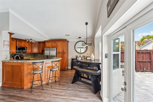 5081 SW 154th Pl, Miami, FL 33185 - kitchen featuring appliances with stainless steel finishes, a sink, a textured ceiling, crown molding, and brown cabinetry