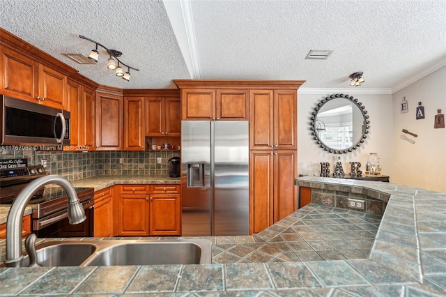 5081 SW 154th Pl, Miami, FL 33185 - kitchen with appliances with stainless steel finishes, a sink, arched walkways, glass insert cabinets, and tasteful backsplash